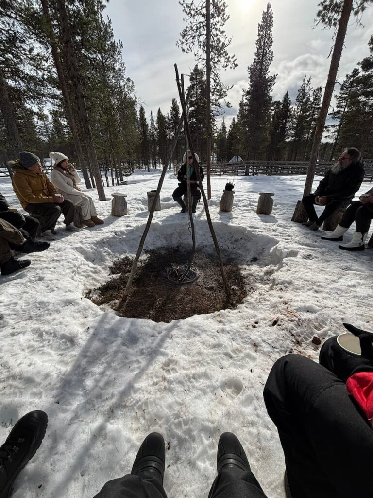People sitting around an outside firepit