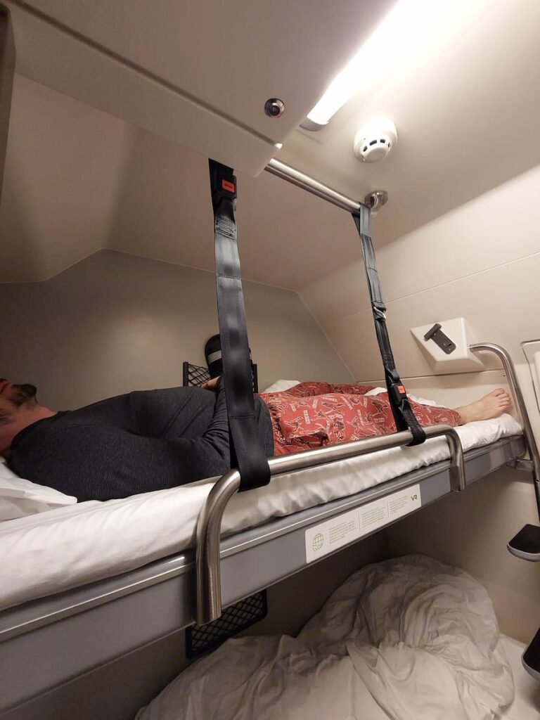 Daniel stretched out on a bed on Santa Claus Express