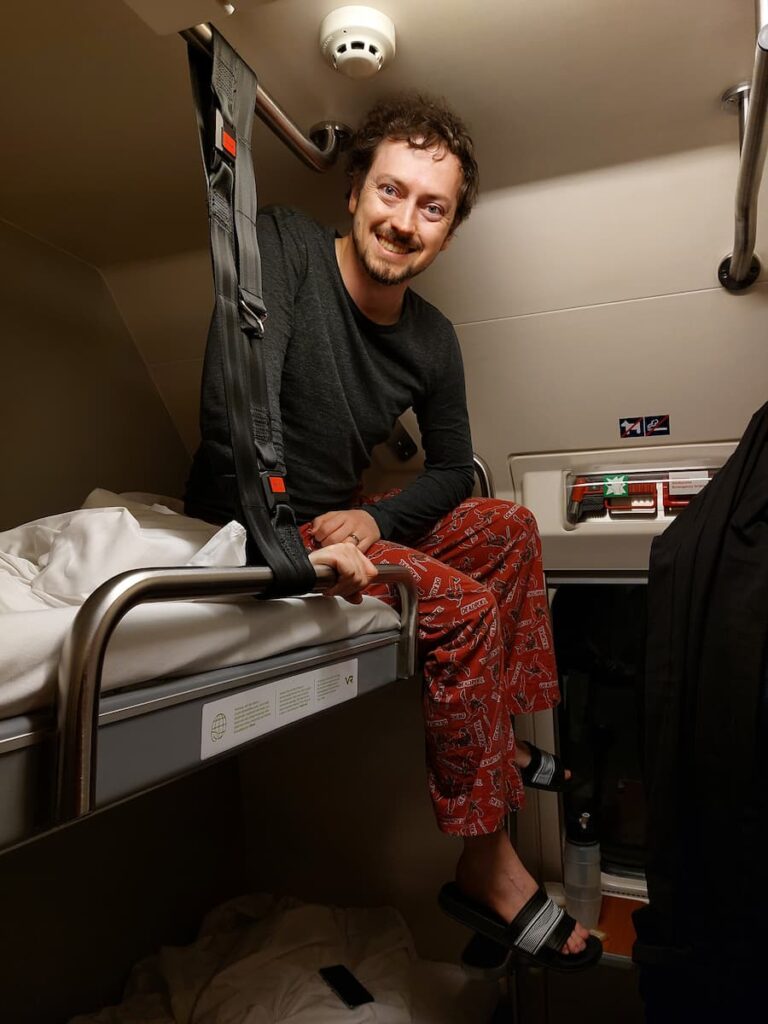Santa Claus Express Train: The Ultimate Guide 3 Daniel sitting on the top bunk on the Santa Claus Expres train
