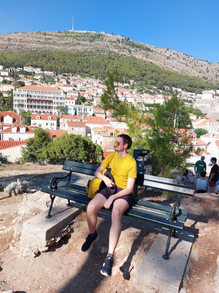 Daniel sitting on a high bench