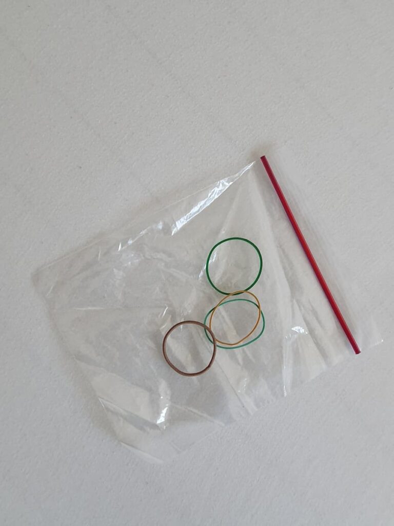 Ziploc bag, elastic bands and a hairband