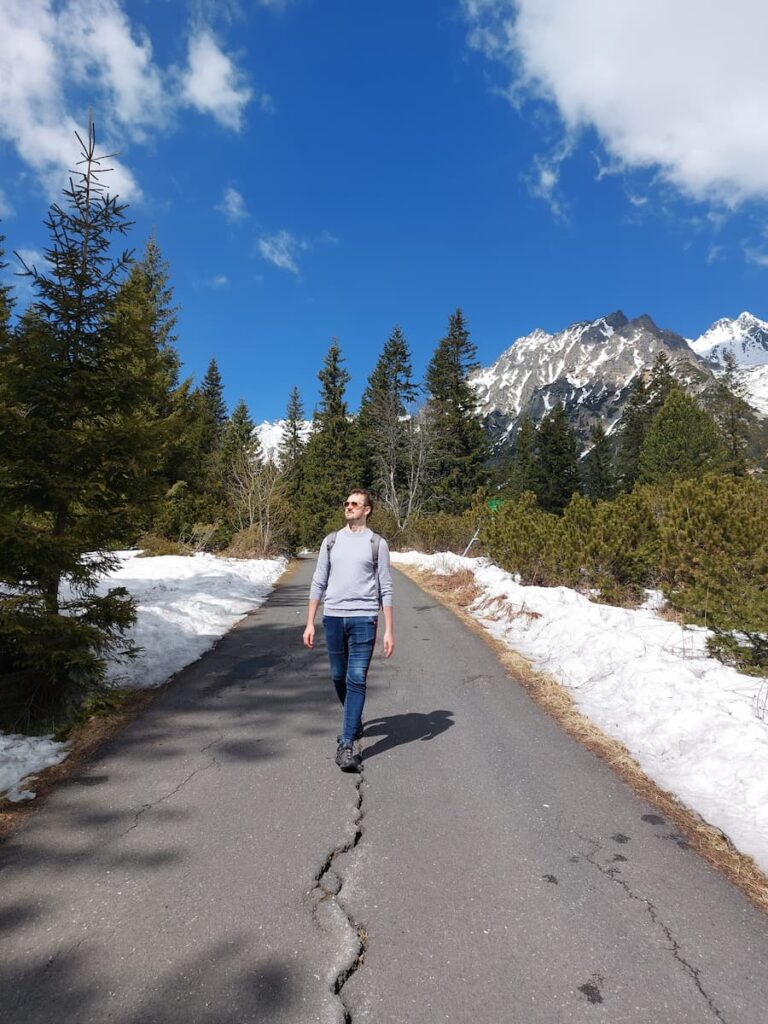 Daniel walking on an asphalt path