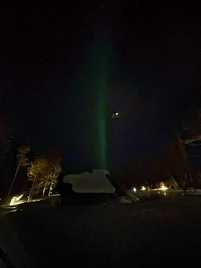 A pale, thin beam of the aurora