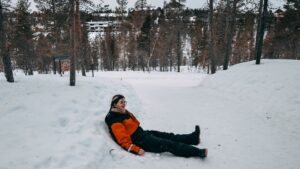 Mirka sitting on a snow path in Lapland
