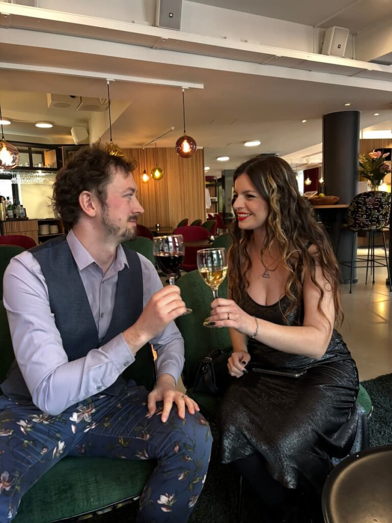 Mirka and Daniel doing cheers with wine on their wedding day at Andersen Hotel