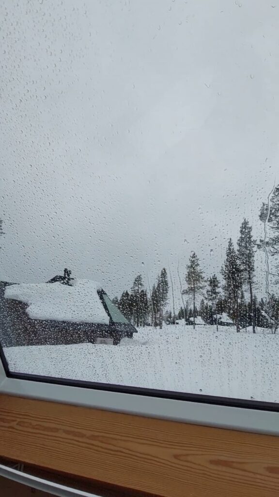 Rain on the window of an Aurora Cabin