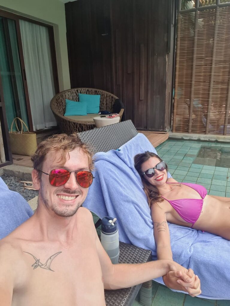Mirka and Daniel smiling on sun loungers on their swim-up terrace