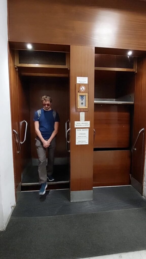 Paternoster Elevator in Prague: All You Need to Know 3 Daniel getting out of a paternoster lift