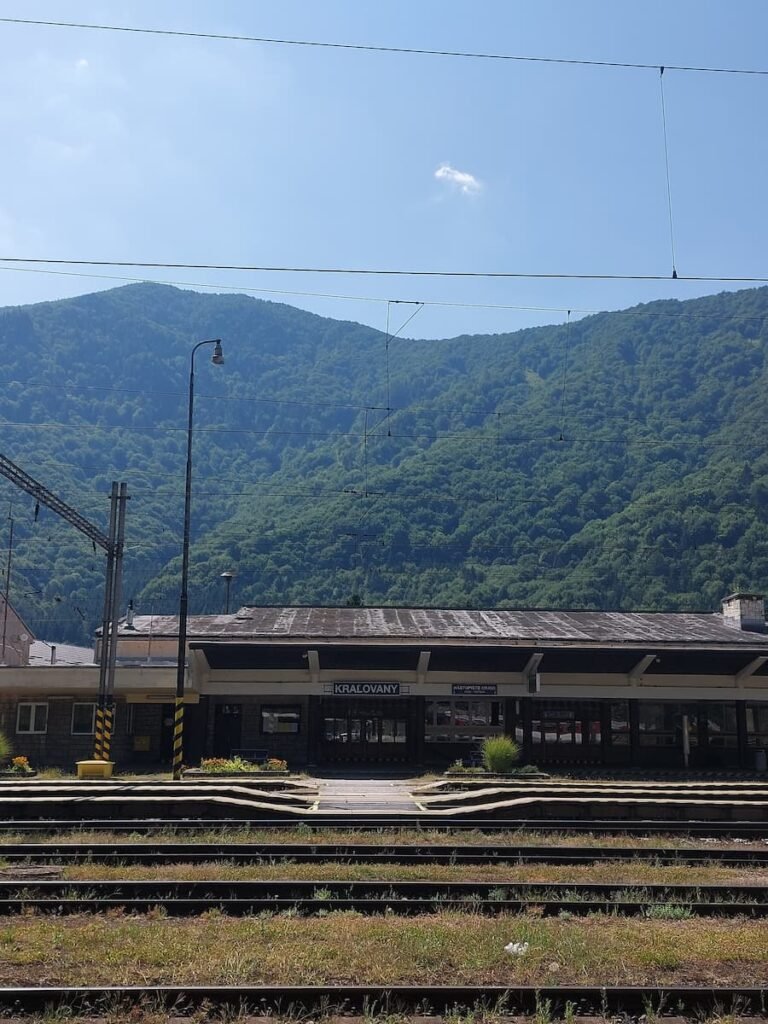 How to Visit Orava Castle Without a Car (+ Insider Tips) 6 Kraľovany train station with green hills around