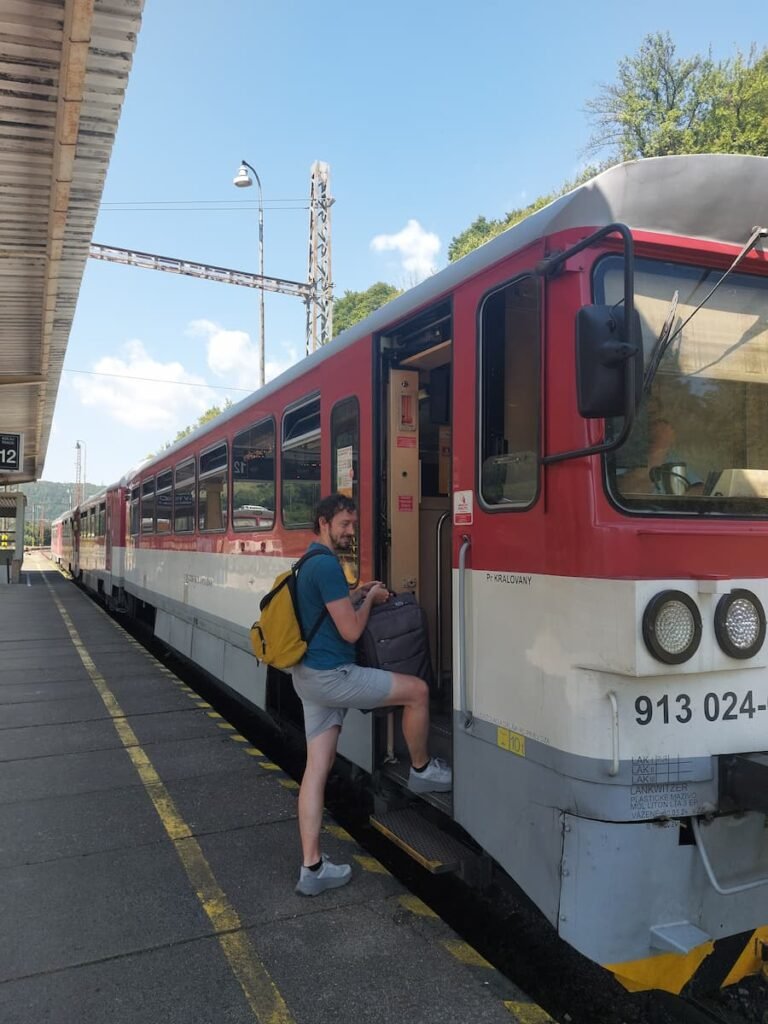 How to Visit Orava Castle Without a Car (+ Insider Tips) 5 Daniel getting on a train with a suitcase