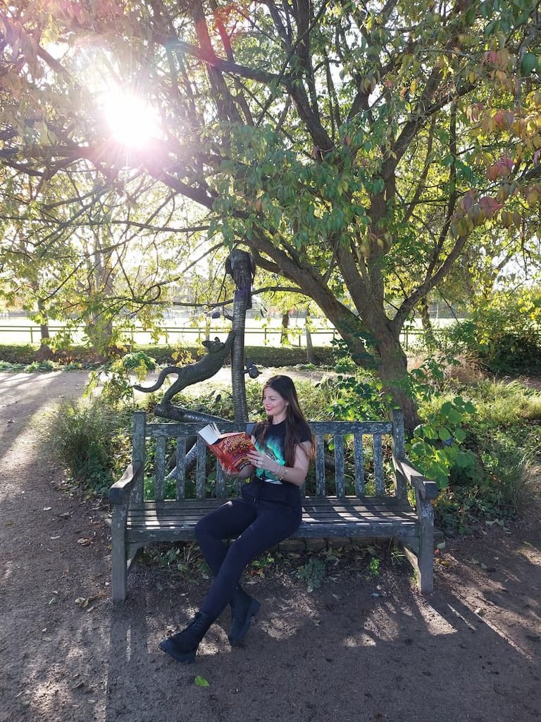 Mirka reading Book of Dust on Lyra's bench 