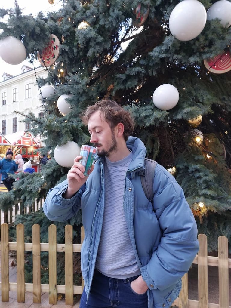 Daniel drinking an absinthe cocktail at the Bratislava Christmas market