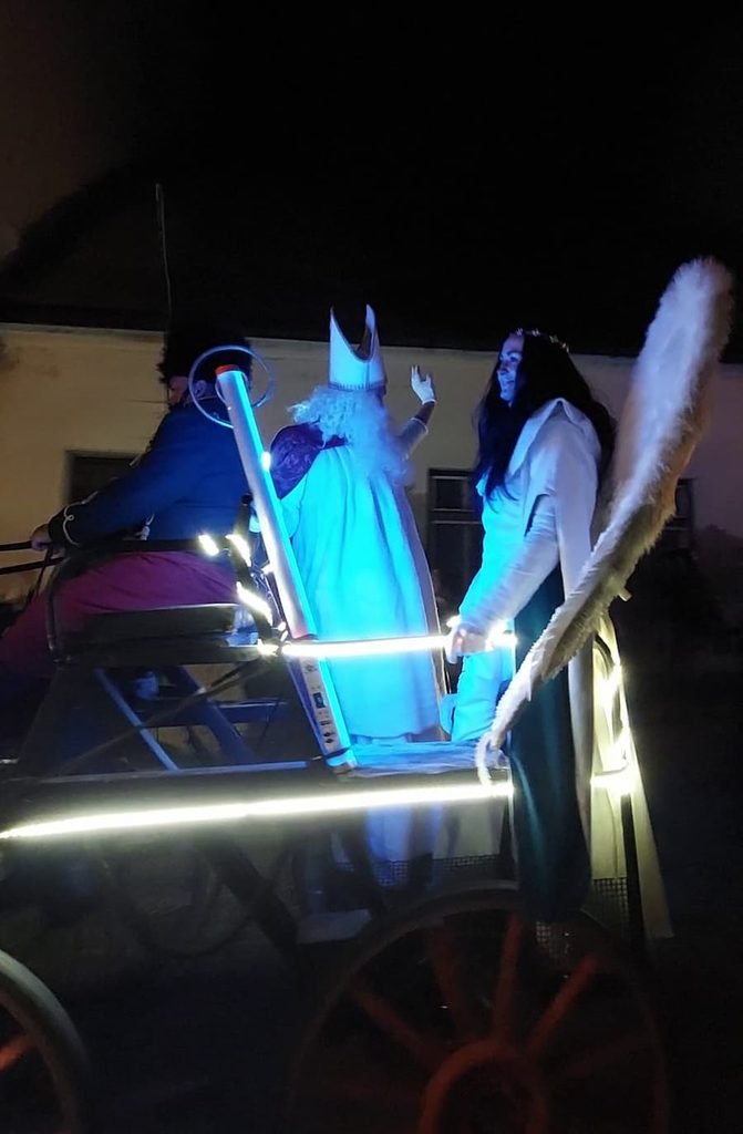 St Nicholas and an angel on a carriage