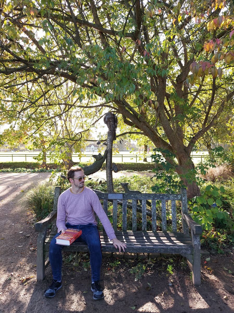 3 Days in Oxford: A Harry Potter & His Dark Materials Itinerary 2 Daniel sitting on Lyra's bench in Oxford Botanic Garden